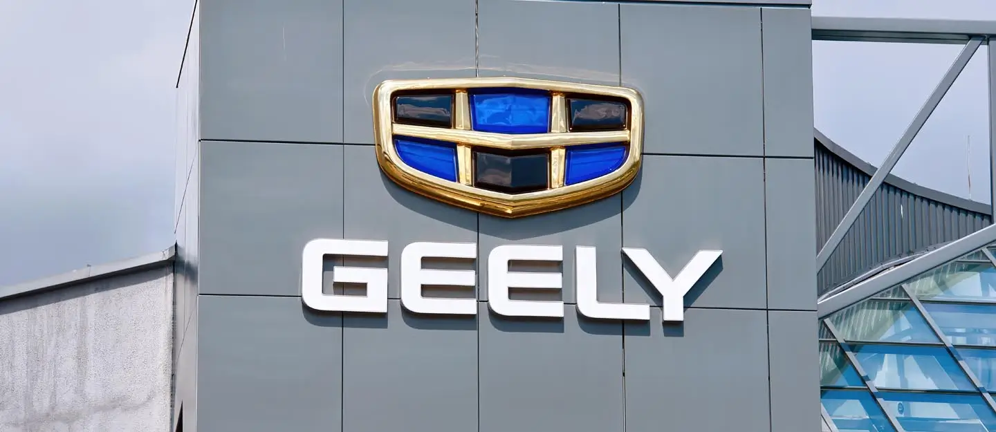 Geely showroom and service center with prominent company logo displayed on the building exterior, representing Geely's expansion into new markets.